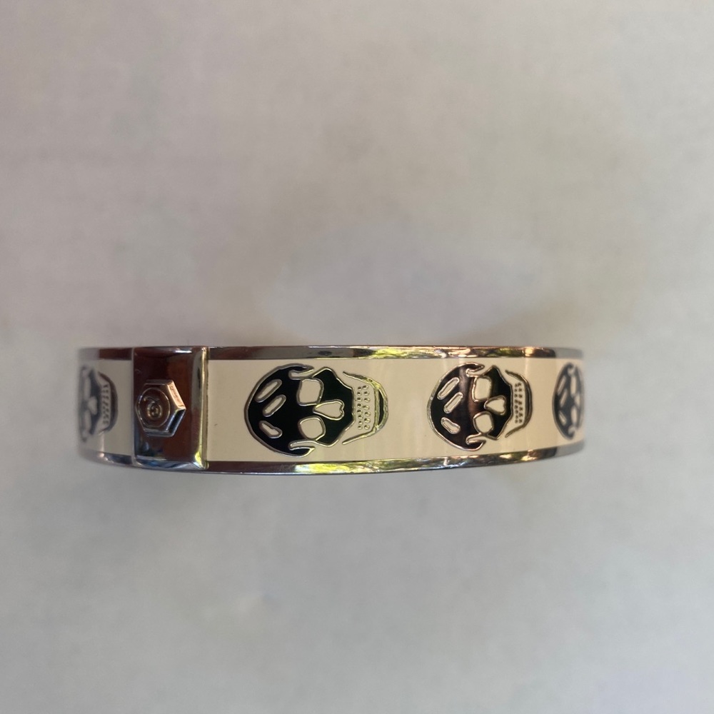 Alexander McQueen aluminum and enamel skull bangle.